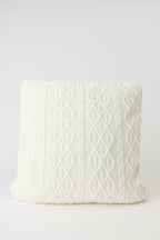 Coussin en tricot torsadé